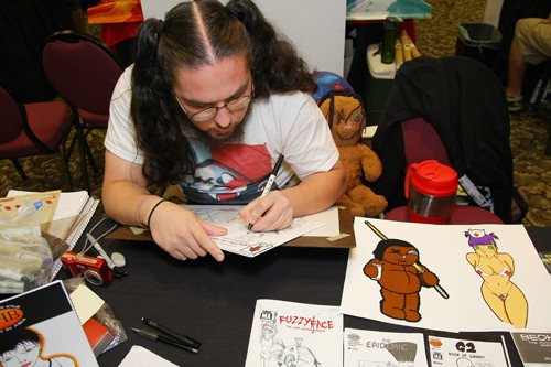 Gordon Bates / Arizona Daily Wildcat
Fuzzy Face Comics John Chihak is at The Hotel Arizona for Tucsons 2009 Comic Con. Between talking to guests of the convention and conferring with his associates, he keeps the creativity flowing by making comic character sketches at his booth.