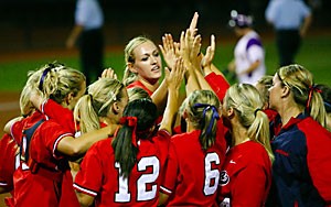 Players high five pitcher Alicia Hollowell after Arizona defeated LSU 14-5 in the third game of the super regionals on Saturday at Hillenbrand Stadium. Arizona goes on to play Pac-10 rival Oregon State in the first game of the Womens College World Series today. 