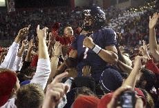 UA quarterback Willie Tuitama celebrates with fans after a 31-10 win over ASU Saturday night at Arizona Stadium. Tuitama beat the Sun Devils for the first time in his career and the Wildcats earned a spot in the Las Vegas Bowl on Dec. 20 against No. 17 BYU. 