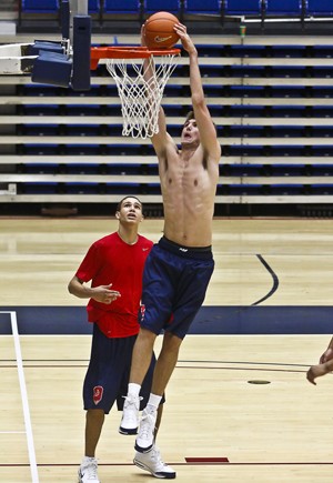 Center Jeff Withey dunks past forward D.J. Shumpert in a Sept. 12 practice in McKale Center. Its been reported by several publications that Withey will transfer from the Wildcat program.