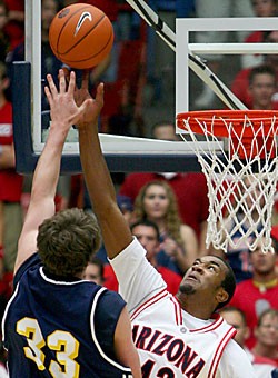 Freshman forward Jordan Hill denies NAU forward Kyle Landry with a block near the basket in No. 15 Arizonas 101-79 win over NAU Wednesday in McKale Center. Hill started the second half and blocked three shots in the game, to go along with his eight points and four rebounds. 