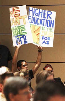 Amanda Purciello / Arizona Daily Wildcat

A student holds up different protest signs during the ABOR meeting held yesterday morning in the North Ballroom of the Student Union Memorial Center.