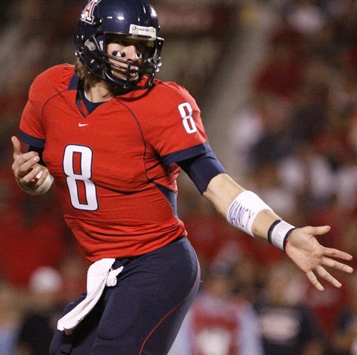 Redshirt sophomore Nick Foles? dedication to his aunt is visible as he hands the ball off during Arizona?s game against UCLA on Oct. 24. Foles is just one of the Wildcat Football players that uses their equipment accessories to dedicate to certain individuals. 