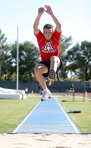 UA long jumper Luis Rivera leaps into the dirt pit during practice yesterday at Drachman Stadium. Rivera has been in the United States for three years after moving from Mexico where he practiced in a city park with a dirt track and no dirt pit.
