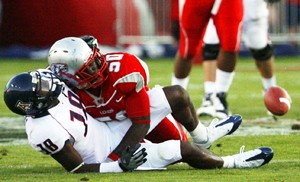 UA wide receiver Mike Thomas watches the ball fall to the turf after getting blasted by New Mexico linebacker Herbert Felder in Saturdays 36-28 Lobo win in Albuquerque, N.M.