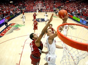 Arizona guard Jerryd Bayless, right, is fouled by Stanford forward Lawrence Hill on a fastbreak layup in a 67-66 Cardinal win in McKale Center on Saturday. Bayless completed the three-point play with a free throw, one of his 16 converted shots from the charity stripe in the game.