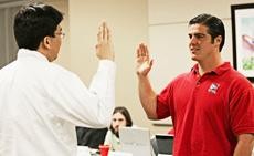 Former Graduate and Professional Student Council President Stephen Bieda, an atmospheric sciences graduate student, swears in GPSC President-elect David Talenfeld, an M.B.A. candidate, in the Tucson Room of the Student Union Memorial Center on Wednesday.