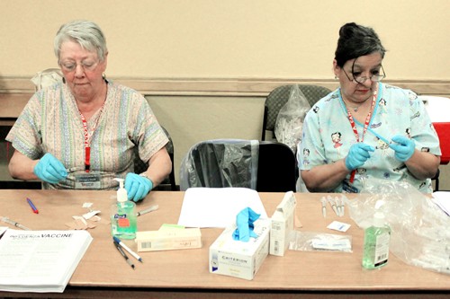 Lisa Beth Earle / Arizona Daily Wildcat

Nurses Alberta Hopkins and Cecilia Martinez prepare H1N1 shots at El Portal Residence Hall on Wednesday, Nov. 4. The shots were only administered to high risk people because Campus Health received a limited amount.