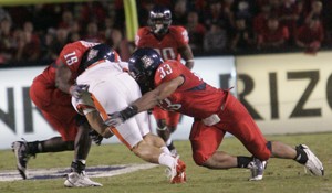 UA linebackers Xavier Kelley (15) and Ronnie Palmer (33) combine for a tackle in a 19-17 Beaver win at Arizona Stadium on Nov. 22. We just have to focus on Arizona and hope that the fans and the media dont blow it out of too much preparation, Palmer said of Saturdays game with ASU.