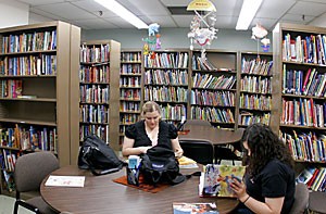 Education seniors Stacy Marr, right, and Syleena Firkins, left, do homework amidst shelves holding the largest collection of childrens books in the country.