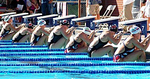 Members of the UA womens swimming team line up with the Wisconsin team in preparation for the backstroke. Both the women and the men will compete today against USC and the UCLA women. 