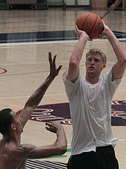 Freshman guard Chase Budinger rises up for a jump shot over sophomore forward Marcus Williams during a pick-up game Saturday evening in McKale Center. Budinger, who sports a vertical jump of more than 40 inches, begins practice tomorrow with the rest of the squad.
