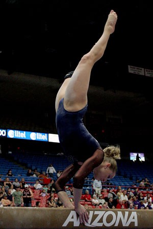 Gymcats senior Karin Wurm performs on the beam last Friday against Washington in McKale Center. This weekend the team heads to Kentucky for a tri-meet against Western Michigan and Kentucky.