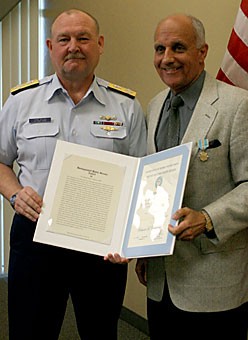 Richard Carmona, right, a public health professor and former U.S. surgeon general, is presented an award by Adm. Thad W. Allen, commandant of the U.S. Coast Guard. The Coast Guard awarded Carmona for the work he did after Hurricane Katrina.