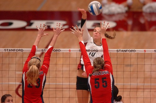 Arizona middle blockers Courtney Karst, No. 23, and Stephanie Snow, No. 55, defend against a Stanford hit during Sunday?s loss.