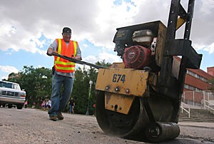 Ron, a City of Tucson employee, fills a pothole on North Park Avenue Thursday afternoon. There are more than 20 roads that are awaiting repair by Facilities Management.