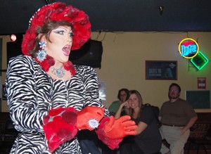 Lady Ashley performs in the drag queen fashion show at Howl at the Moon sports pub on West Prince Road. The show was a fundraiser for the Walking Names Project, which sponsors students to participate in the annual AIDS Walk, taking place this Sunday on campus.