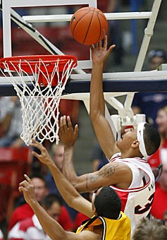Sophomore Marcus Williams guides the ball into the basket in Arizonas exhibition game against Victoria Nov. 11 in McKale Center. After flirting with the NBA, Williams, who averaged 13 points per game as a freshman returned to be Arizonas go-to-guy.