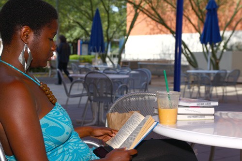 Gordon Bates / Arizona Daily Wildcat 

Melissa Kiguwa, a political science senior, enjoys the leisure of the shaded area east of the SUMC food court as she reads and enjoys her cool refreshment.