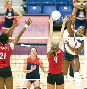 UA outside hitter Tiffany Owens swats the ball into a Washington State front line in a 3-0 win over the Cougars in McKale Center on Sept. 26. The Wildcats have been preparing for this upcoming weekend in the Bay Area by running through a drill called Man vs. Wild.