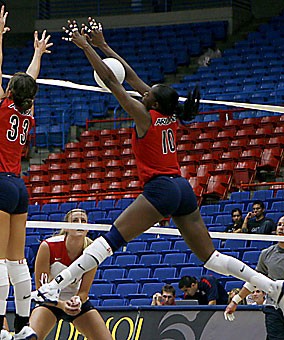 Dominique Lamb (10) stuffs a kill attempt in the Arizona volleyball teams annual Red-Blue scrimmage Aug. 19 in McKale Center. The middle blocker Lamb set a new career-high with 12 blocks in a match last weekend.