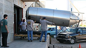 Gentle Bens employees help unload a 2,800-gallon brew tank into the Barrio Brewery, the new location where all of Gentle Bens beer will be brewed, yesterday afternoon in downtown Tucson.