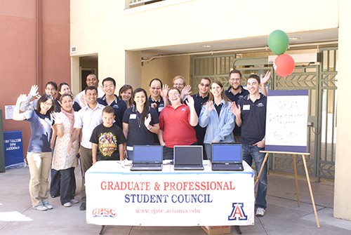 Koby Upchurch / Arizona Daily Wildcat

Clarissa Sema (center,red shirt), college of pharmacy student and Graduate and Professiona Student Councit president, poses for a group photo with members of the council and students and their families.  The GPSC met at La Aledea courtyard in graduate student housing Sunday to kick off graduate student appreciation week.
