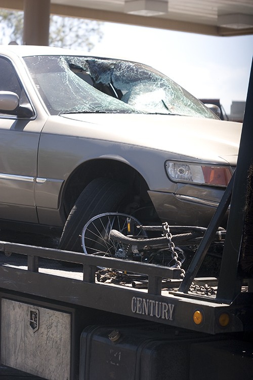 Ginny Polin / Arizona Daily Wildcat

The bent bicycle of a 22-year-old UA student and the car that he hit sit on the back of a tow truck Tuesday near the intersection of Speedway Boulevard and Park Avenue.  Thy cyclist was struck as he waited at the intersection in the left turn lane and the intersection was shut down for two hours.
