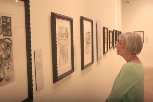 Emily Moore / Arizona Daily Wildcat 

Tammy Bearden a volunteer at the UA Museum of Art admires the new exhibit Pictures of the Floating World. 