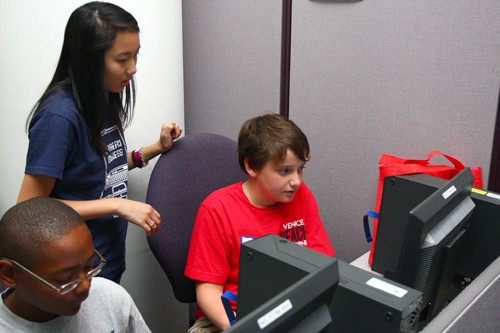 Gordon Bates / Arizona Summer Wildcat
Michelle Mah, a junior in finance, helping Toby (right), 11 years old and going into 6th grade, during one of this summers My Dream Business workshops. The objective of the workshop is to educate young children in the steps that are required to start a business and to familiarizes them with the software that they might need in doing so.