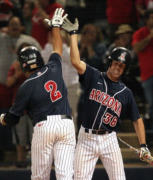 Arizona designated hitter Colt Sedbrook, left, congratulates shortstop Bryce Ortega in an 4-3 extra-inning loss to No. 23 UCLA at Sancet Stadium on March 28. The Wildcats have 23 games in the next 30 days.