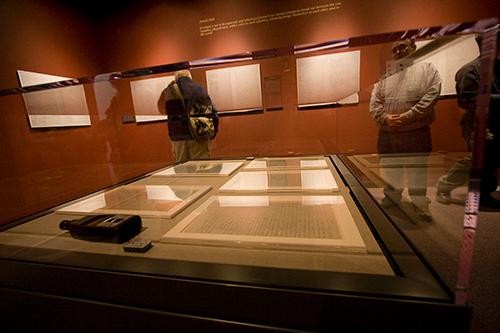 Michael  M. Brescia, Ph.D., associate curator at the Arizona State Museum, keeps watch over Treaty of Guadalupe that is currently on display at the museum.  Today marks the 133 anniversary of the signing.