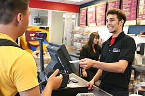 Pre-business freshman Tyler Shira uses his CatCard to buy his lunch from Brueggers Bagels employee and physiology junior Matthew Marquez in the Park Student Union yesterday afternoon.