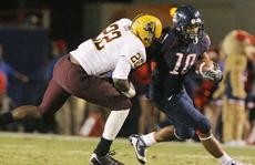 Former Arizona wide out Mike Thomas tries to evade ASUs Rodney Cox during a 31-10 UA win on Dec. 6 at Arizona Stadium. Thomas and former UA left tackle Eben Britton will likely be selected in this weekends NFL Draft.