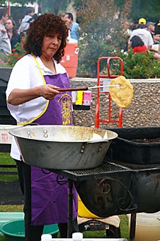 Juana Casillas of the Blessed Kateri Tekakwitha Native American Church finishes cooking a piece of fry bread yesterday afternoon at the Tucson Meet Yourself festival at El Presidio Park. The three-day event was a chance for Tucsonans to taste, hear and experience local culture.