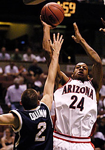 UA freshman Andre Iguodala shoots over Notre Dames Curtis Quinn during yesterdays Sweet 16 matchup in Anaheim, Calif.