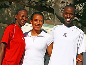 Senior runner Robert Cheseret, right, stands with his wife Dorcas Chepkoech, center, and his sister Irene Lagat in front of the statue of John Button Salmon near McKale Center. Lagat, a sophomore runner at Arizona, and Cheseret are two of 10 siblings who developed a love for running from their parents, Richard and Marsalina.