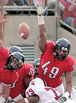 Former UA defensive end Copeland Bryan (49) tries to block a field goal against Stanford last season. Bryan and former teammate Danny Baugher, a punter, are looking to crack the NFL ranks after spending the entire season on practice squads.