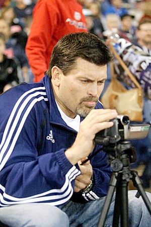 ESPN analyst Mark Schlereth, left, videotapes a UA baseball game to chronicle Arizonas season for ESPN.com. His son, UA closer Daniel, pitches in the Wildcats 8-3 win over Cal State-Fullerton on March 14 at Sancet Stadium. 