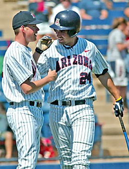 UA ace Preston Guilmet, left, congratulates first baseman C.J. Ziegler after scoring one of his four runs in Arizonas 17-14 win over No. 4 Oregon State yesterday at Sancet Stadium. Ziegler went 5-for-5 with two RBIs in the contest to help Arizona sweep the series.