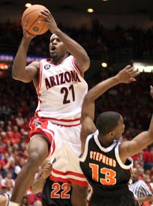 Claire C. Laurence/Arizona Daily Wildcat

Senior guard Hassan Adams shoots over Oregon States Chris Stephens during Arizonas 80-58 victory on Saturday in McKale Center. Adams contributed 8 points and a game high 9 assists.