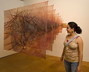 Studio art and religious studies junior, Adrienne Contos admires Moria Geoffrions Corazon yesterday afternoon at the faculty art exhibition.  The exhibition will be showing until Oct. 21 at the UA Museum of Art.
