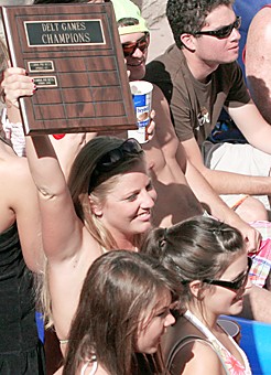 Liz Smith, a health sciences junior and new member educator for Gamma Phi Beta, holds up her sororitys first-place plaque at the Delt Games awards barbecue at the Delta Tau Delta fraternity house on Saturday. Gamma Phi Beta also took the award for best participation in the competition, which raised $4,000 for local charities. 