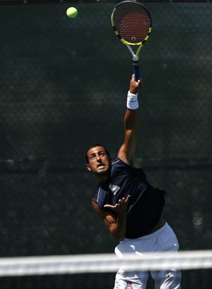 Sophomore Ravid Hazi smashes the ball during a match at the Robson Tennis Center yesterday against Oregon. Hazi won both his singles and doubles matches as Arizona earned its first conference win of the season.