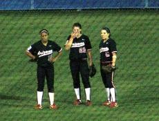 From left, Arizona outfielders Brittany Lastrapes, Lauren Schutzler and Cyndi Duran talk in between innings in Thursdays 1-0 loss to UCLA in the Womens College World Series. The Wildcats take on Alabama on Saturday.