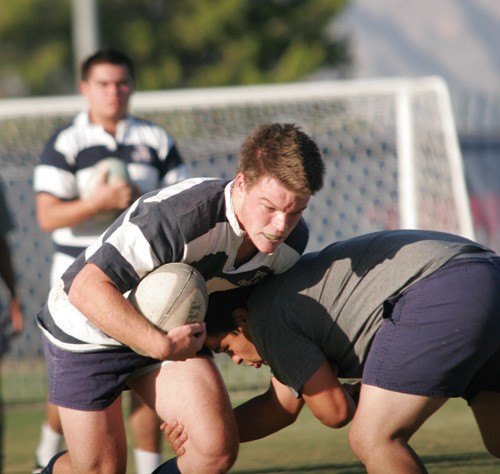 Timothy Galaz / Arizona Daily Wildcat
Jason Fass, 20, a junior, drives with the ball during the Arizona rugby team practice at Rincon Field on Oct. 20, 2009.
