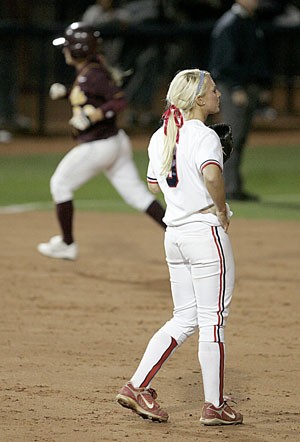 Arizona pitcher Taryne Mowatt regroups as ASU second baseman Mindy Cowles rounds the bases after hitting one of the teams four home runs off Mowatt in last nights 8-1 Sun Devil win at Hillenbrand Stadium. It was ASUs first win in Tucson in 20 years.