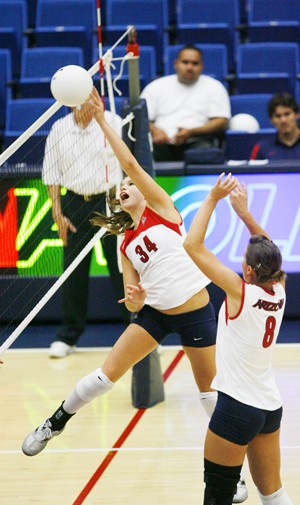 UA setter Paige Weber tips the ball over the net during a 3-0 win over Weber State on Aug. 29 in McKale Center. The volleyball team takes on No. 9 Washington Friday night at 7 and Washington State Saturday night at 7 in a pair of home matches.