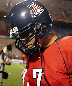 Sophomore quarterback Willie Tuitama walks off the field with his head down after Arizonas 21-10 loss to Washington Saturday at Arizona Stadium. Though Tuitama threw for 308 yards, the offense sputtered and four team captains called a players-only team meeting to air out concerns. 