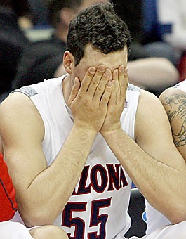 Arizonas Ivan Radenovic covers his face as time winds down on the Wildcats season in their 72-63 loss to Purdue in the first round of the NCAA Tournament. Radenovic and the Wildcats never found their stride in an up-and-down season that started with a 12-game winning streak and ended with an early exit from postseason play.